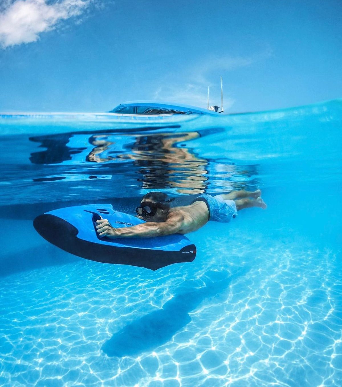 Seabob mirrored on glassy turquoise water at Seven Seas Beach, Fajardo