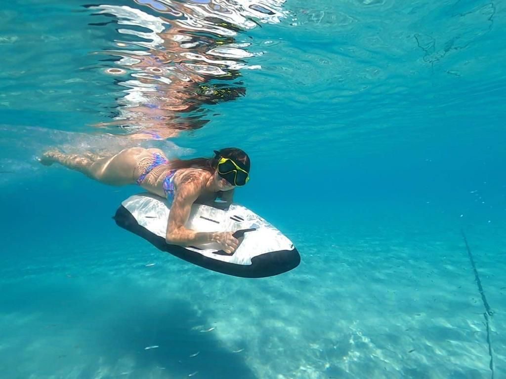 Rider gliding on a Seabob across the turquoise water at Seven Seas Beach, Fajardo, Puerto Rico