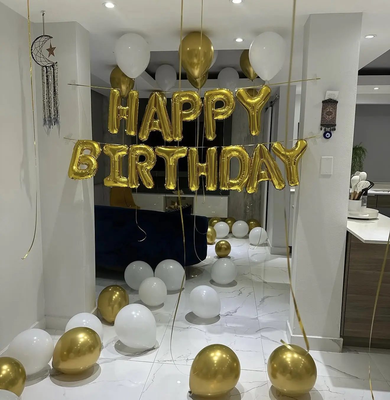 Real gold and white balloon birthday setup with Happy Birthday sign styled by Boating Puerto Rico